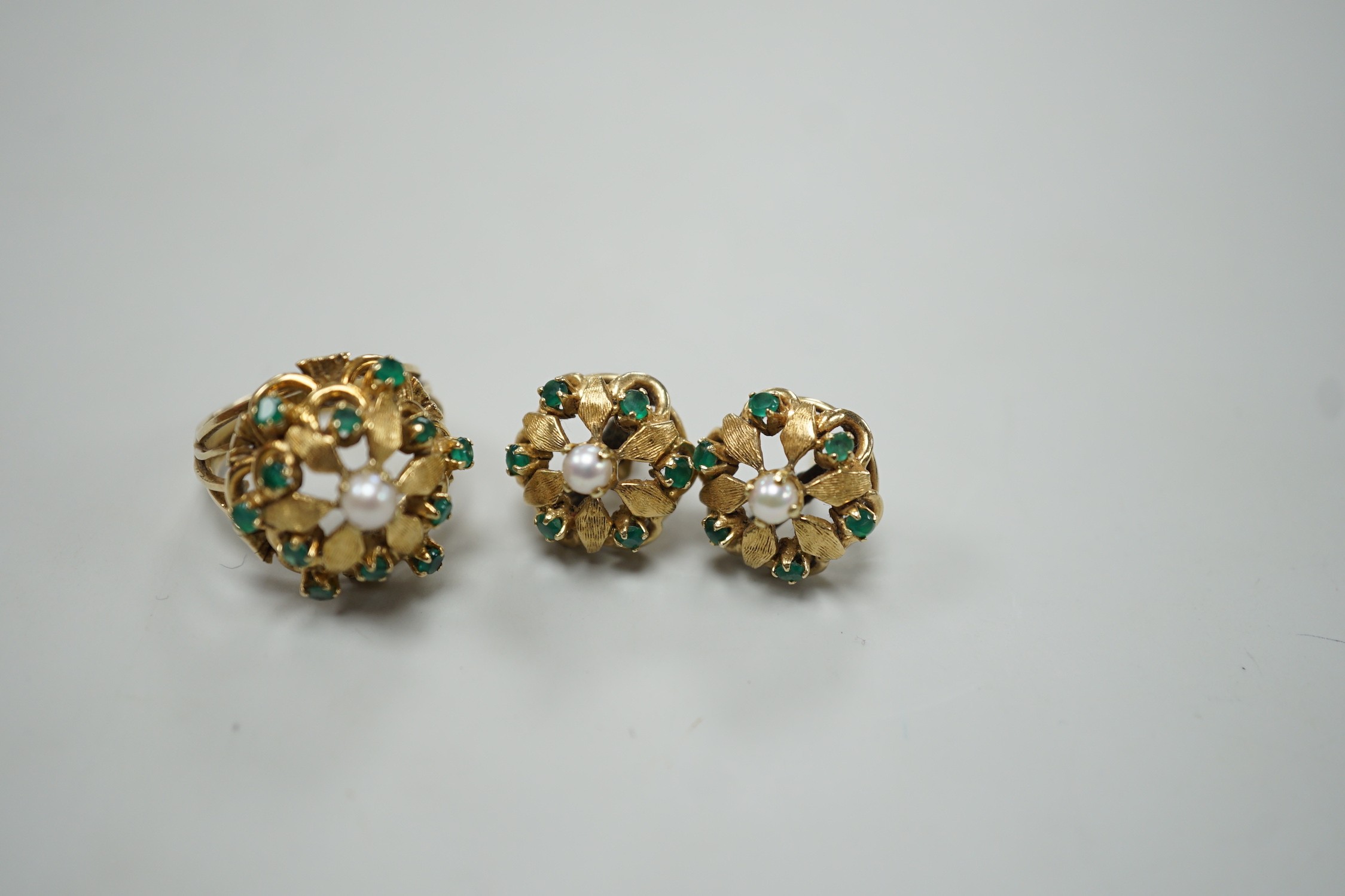 A modern continental, cultured pearl and green stone cluster set dress ring, size N, and a pair of matching earrings, one butterfly missing, gross weight 15 grams.